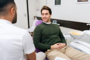 two men having a conversation in dental office